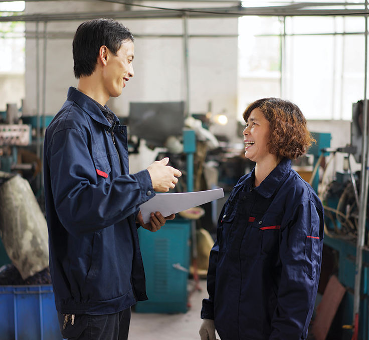 two coworkers talking in shop
